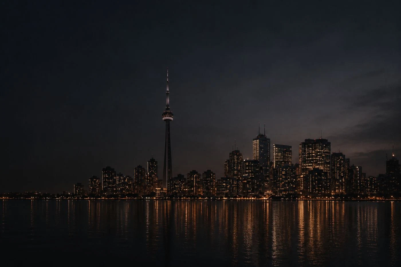 Toronto skyline at night reflected across the lake